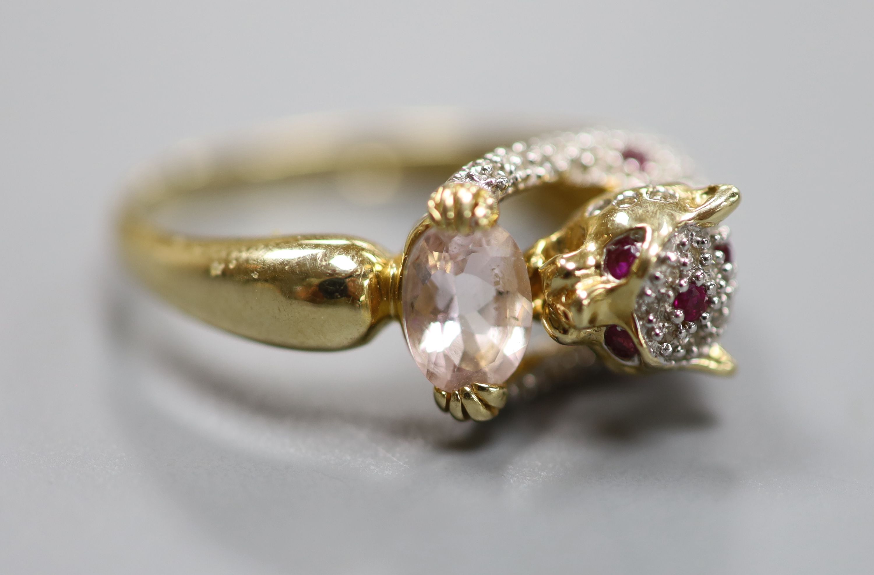 A modern Cartier style 585 yellow metal, pink topaz?, ruby and diamond encrusted leopard ring